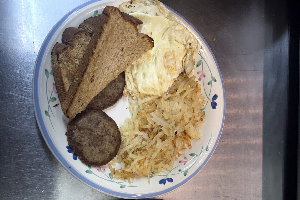 Breakfast plate with eggs, toast, sausage and hash browns